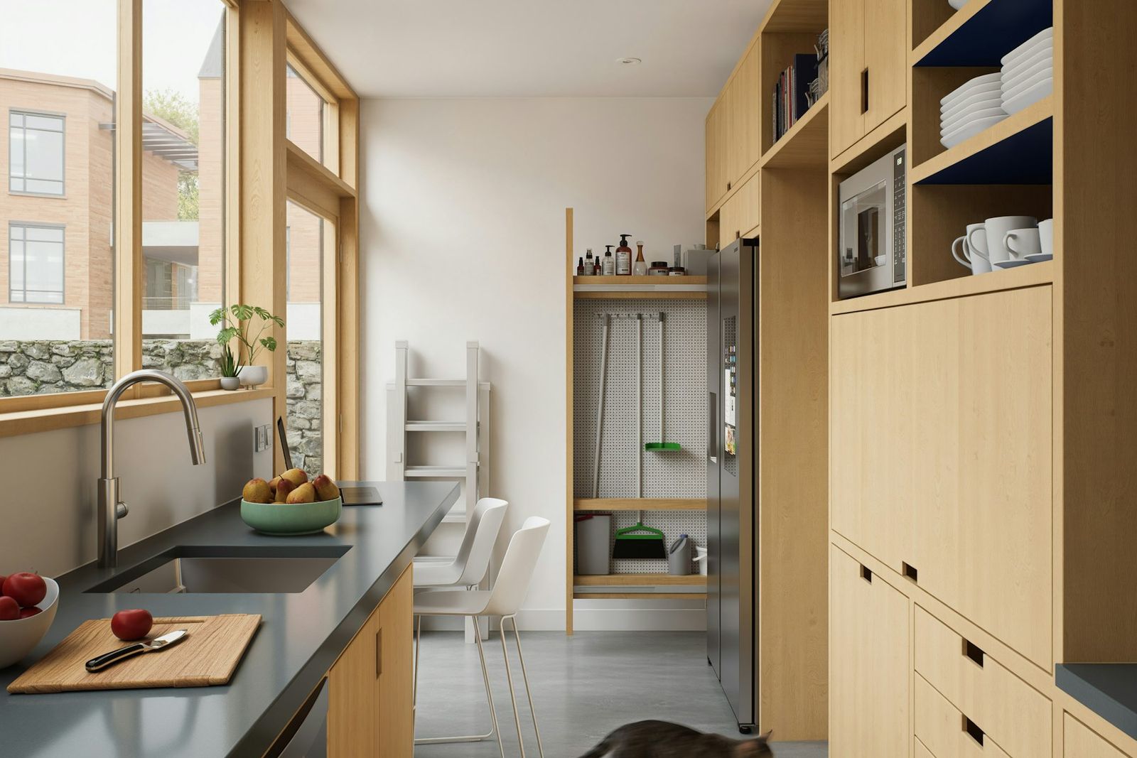 Bright kitchen with light wood cabinets and a window over the sink